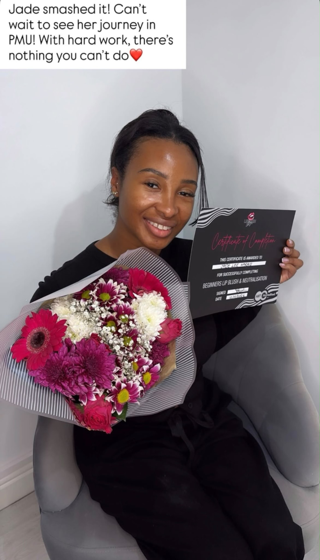 Student holding her certificate and flowers